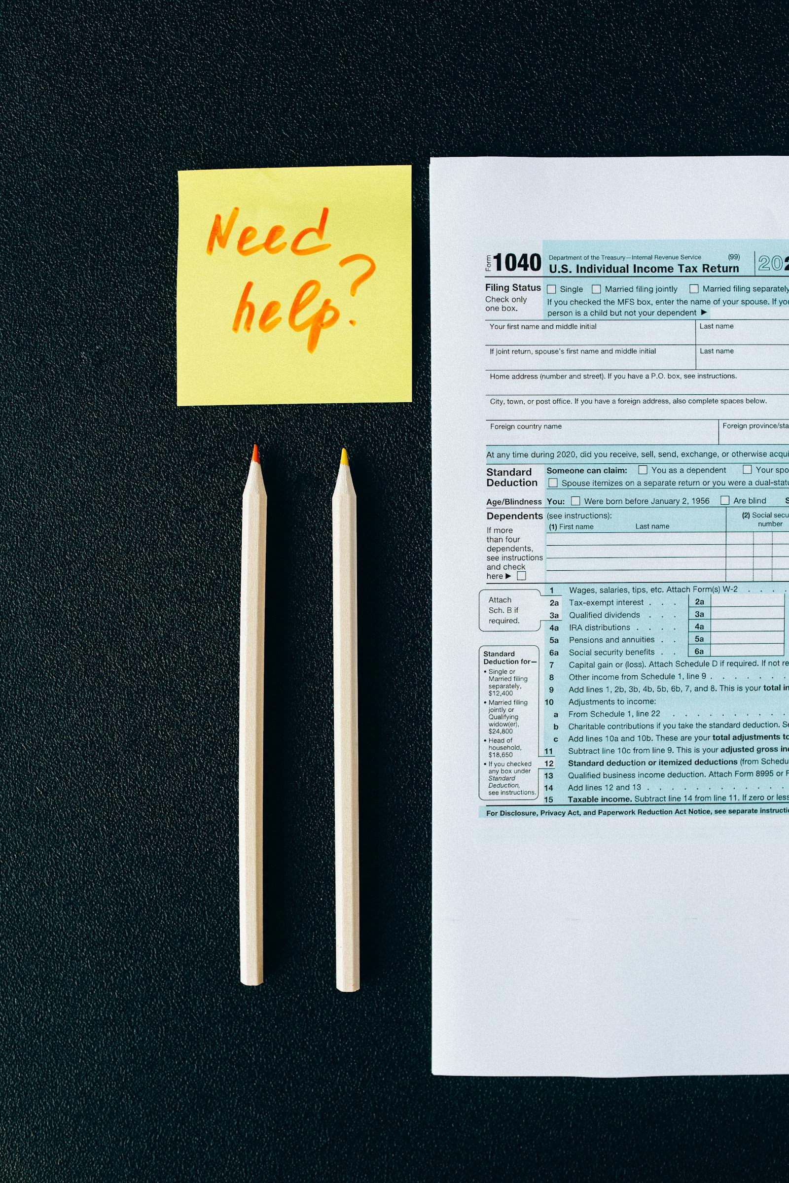 Tax form and help note on a dark workspace